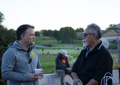 Golfer talking with Chris Baca of Yes Housing.