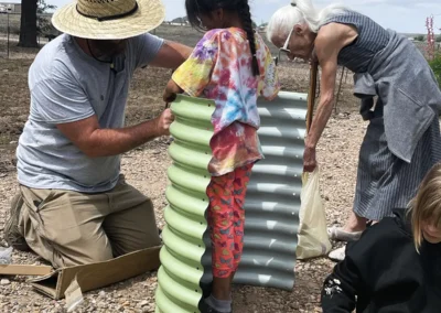 James, kids and residents assembling garden beds at the Roswell Summit development.